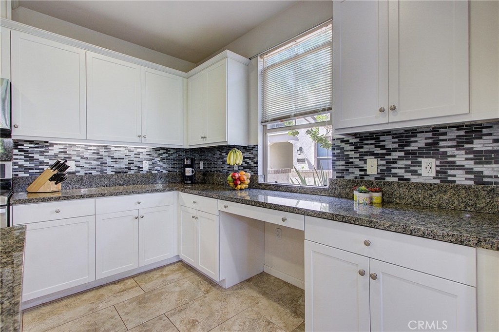 809 El Paseo Lake Forest, CA 92610 - Photo 9 of 45 a kitchen with granite countertop white cabinets and white appliances
