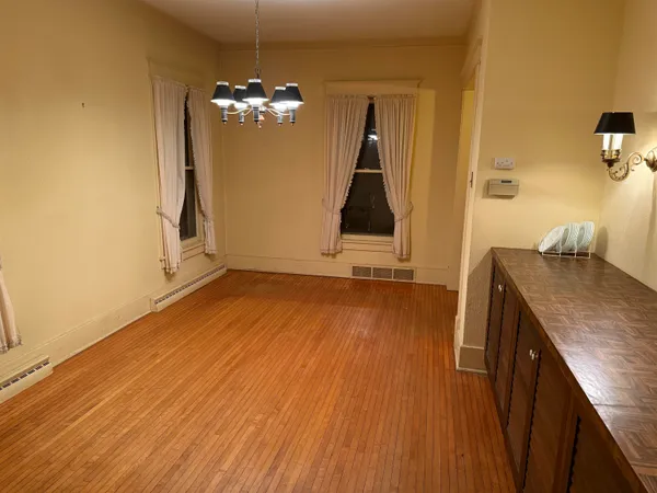 a view of a room with wooden floor and staircase