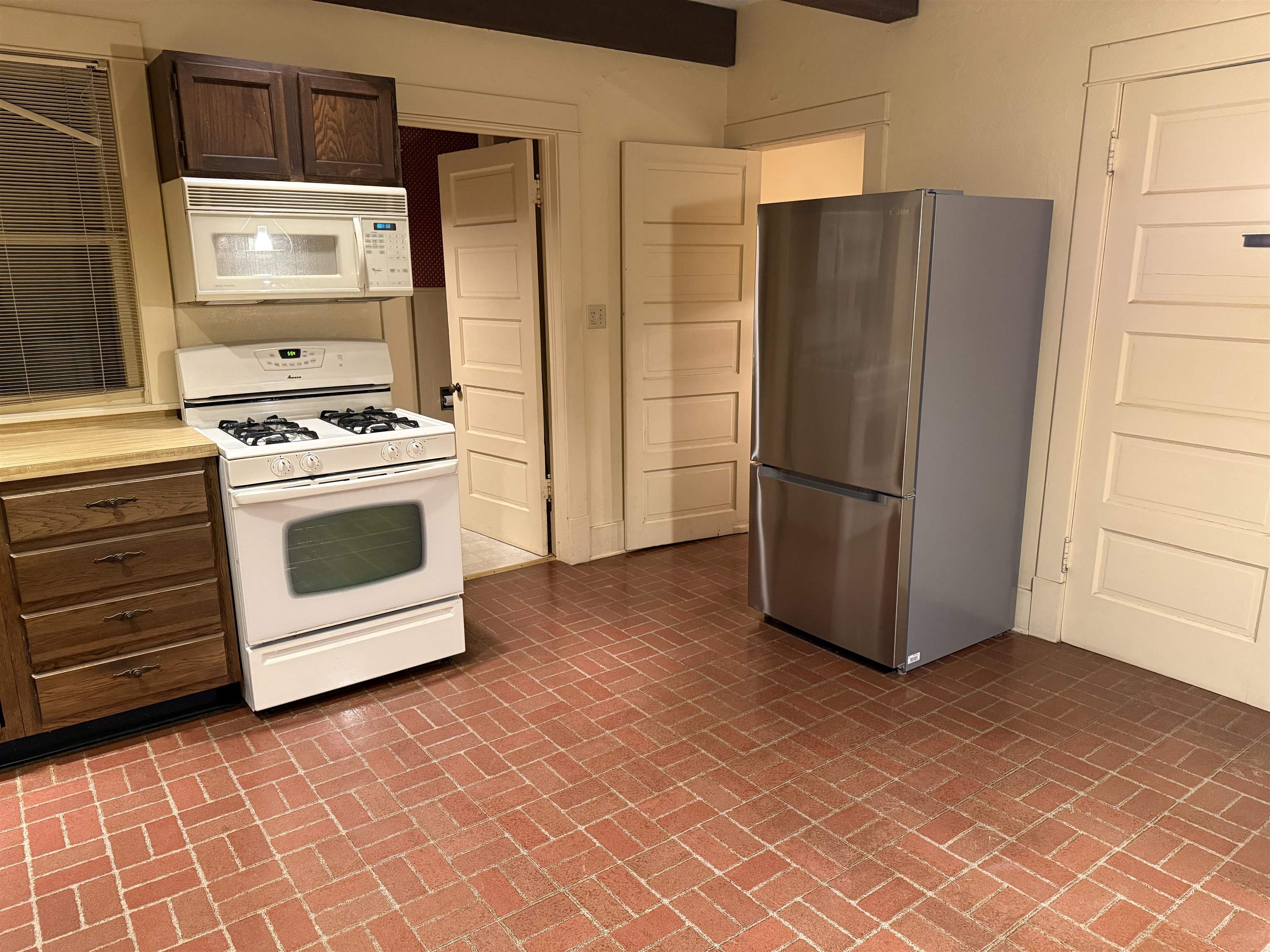 1629 West Harrison Street Freeport, IL 61032 - Photo 4 of 36 a kitchen with a refrigerator and a stove top oven