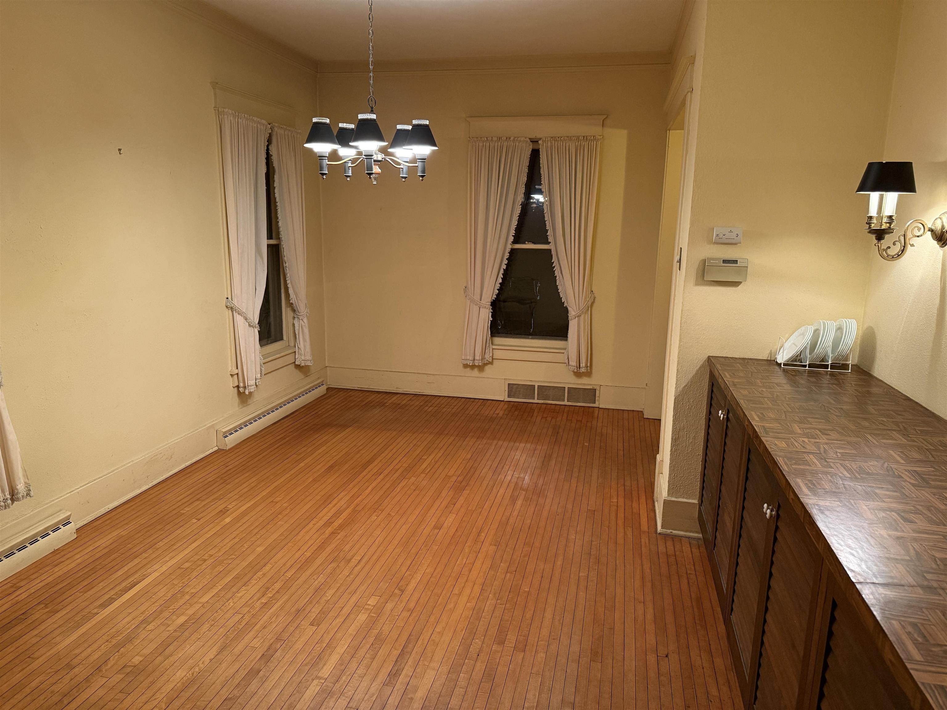 1629 West Harrison Street Freeport, IL 61032 - Photo 9 of 36 a view of a room with wooden floor and staircase
