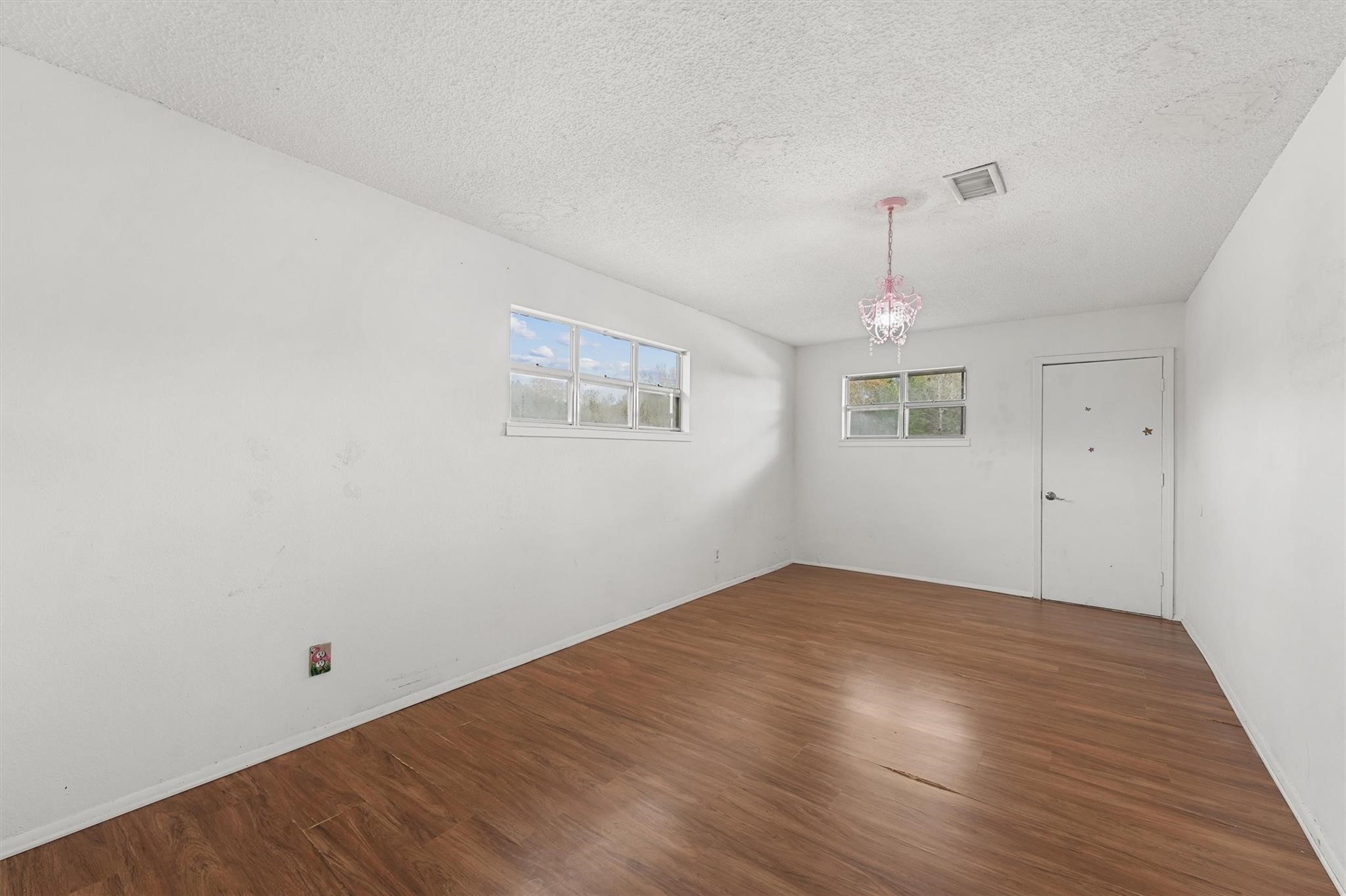 850 County Road 2145 Cleveland, TX 77327 - Photo 19 of 43 a view of empty room with wooden floor