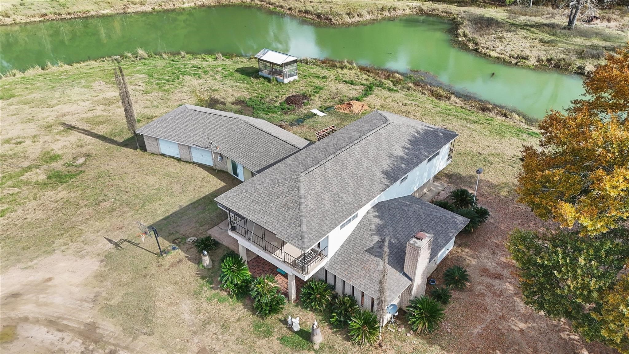 850 County Road 2145 Cleveland, TX 77327 - Photo 2 of 43 an aerial view of a house with a lake view