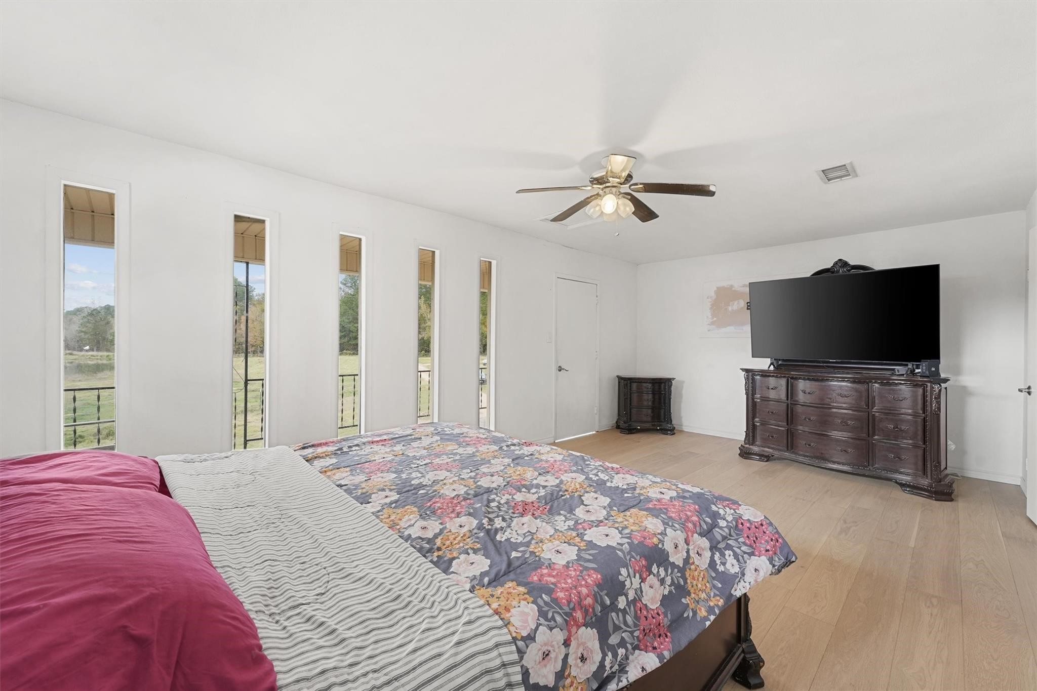 850 County Road 2145 Cleveland, TX 77327 - Photo 25 of 43 a bedroom with a bed and a flat screen tv