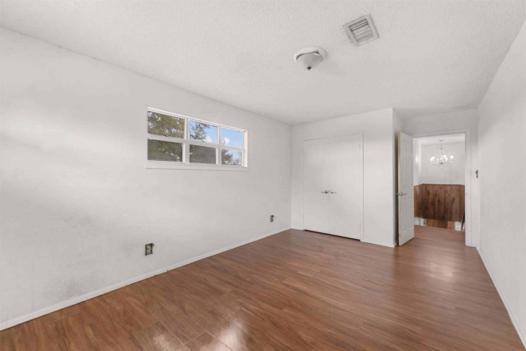 850 County Road 2145 Cleveland, TX 77327 - Photo 28 of 43 an empty room with wooden floor and windows