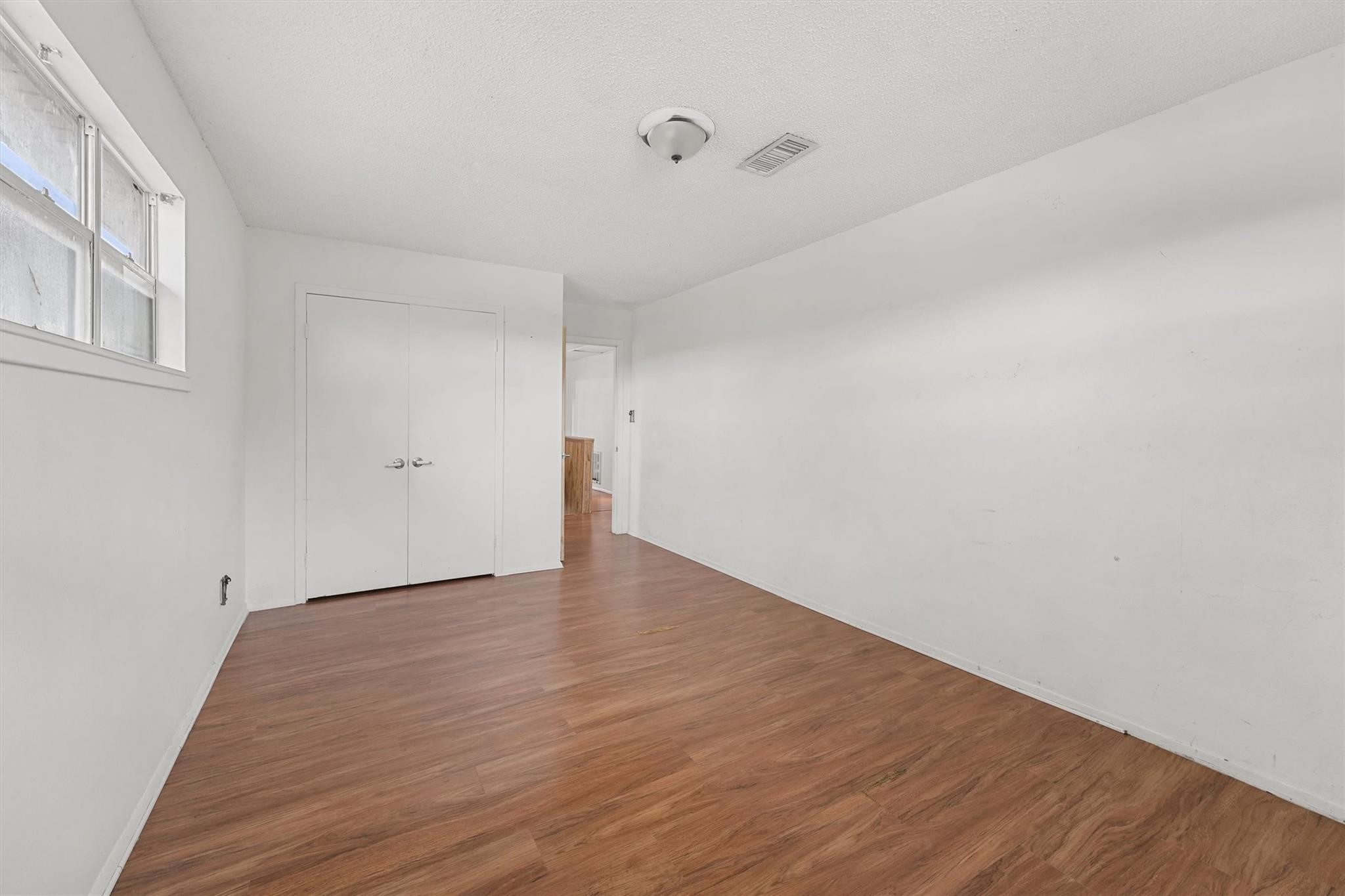 850 County Road 2145 Cleveland, TX 77327 - Photo 29 of 43 a view of an empty room with wooden floor and a window