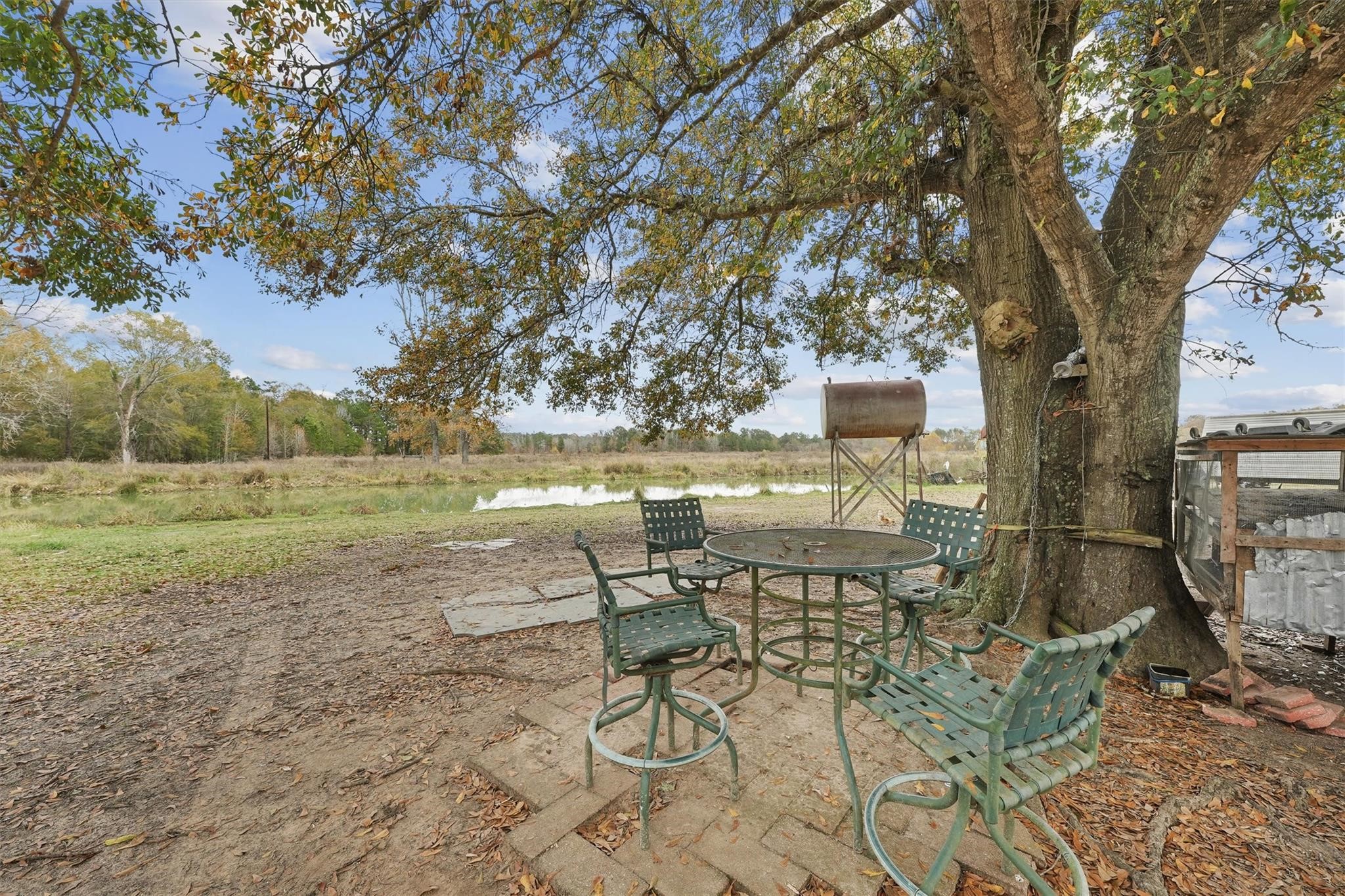 850 County Road 2145 Cleveland, TX 77327 - Photo 35 of 43 a view of a lake with table and chairs