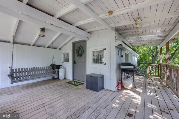 a view of a porch with wooden floor