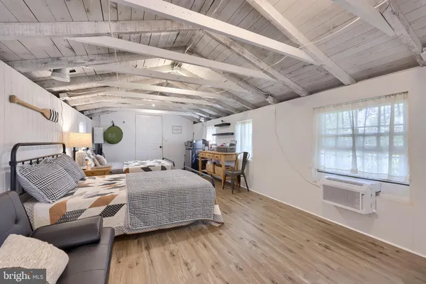 a bedroom with furniture and a wooden floor