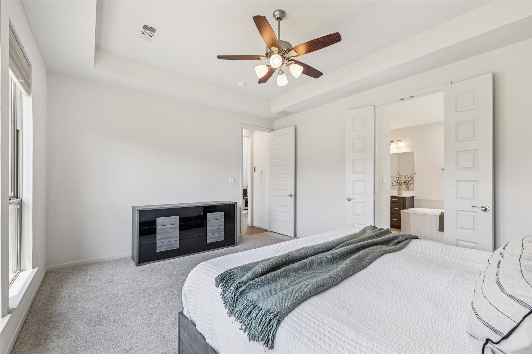 1140 Bryson Rdg Trail Leander, TX 78641 - Photo 14 of 39 This room features light-colored walls and carpet, a ceiling fan with integrated lighting, and a large window