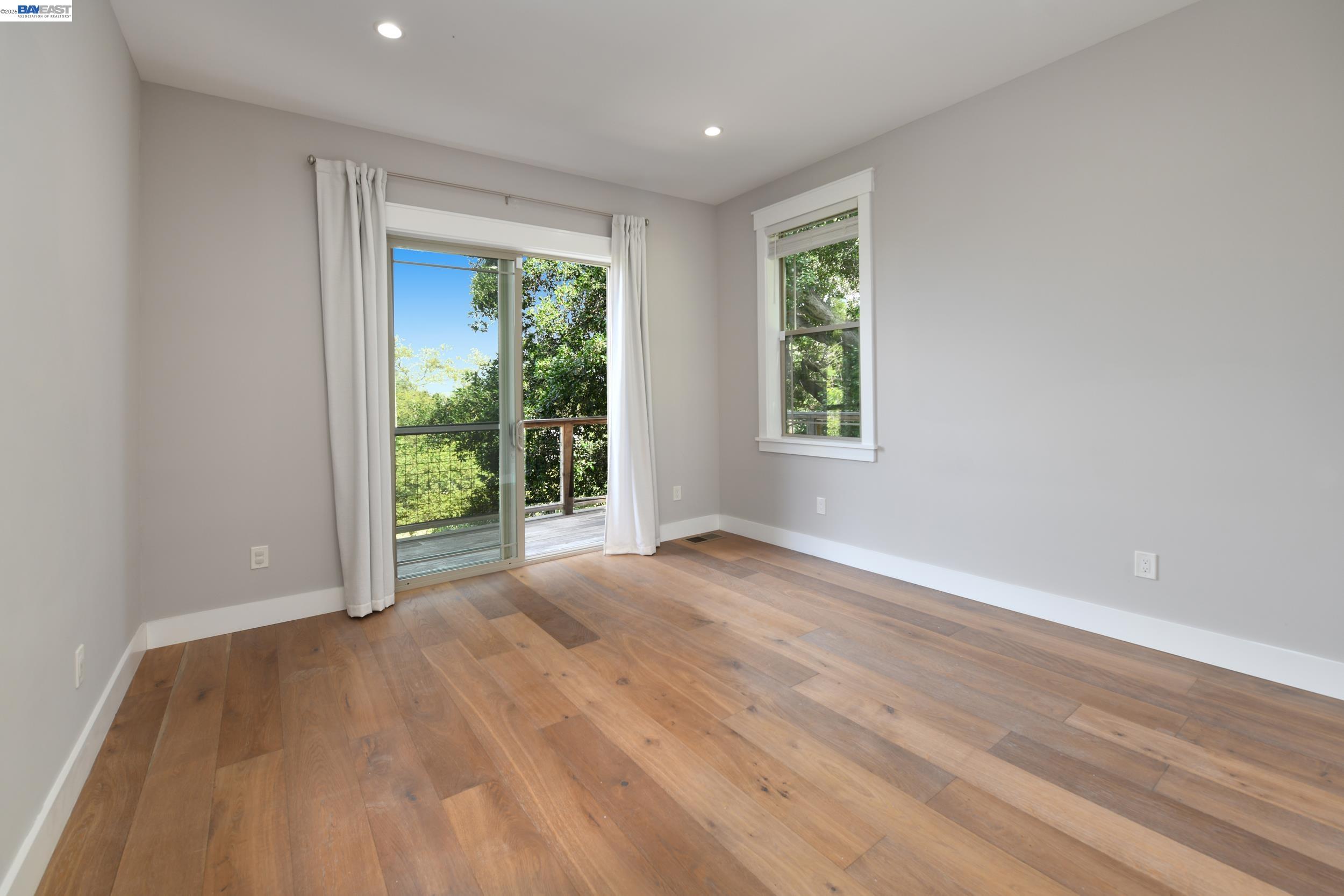 1516 Pleasant Hill Road Lafayette, CA 94549 - Photo 14 of 38 a view of an empty room with wooden floor and a window