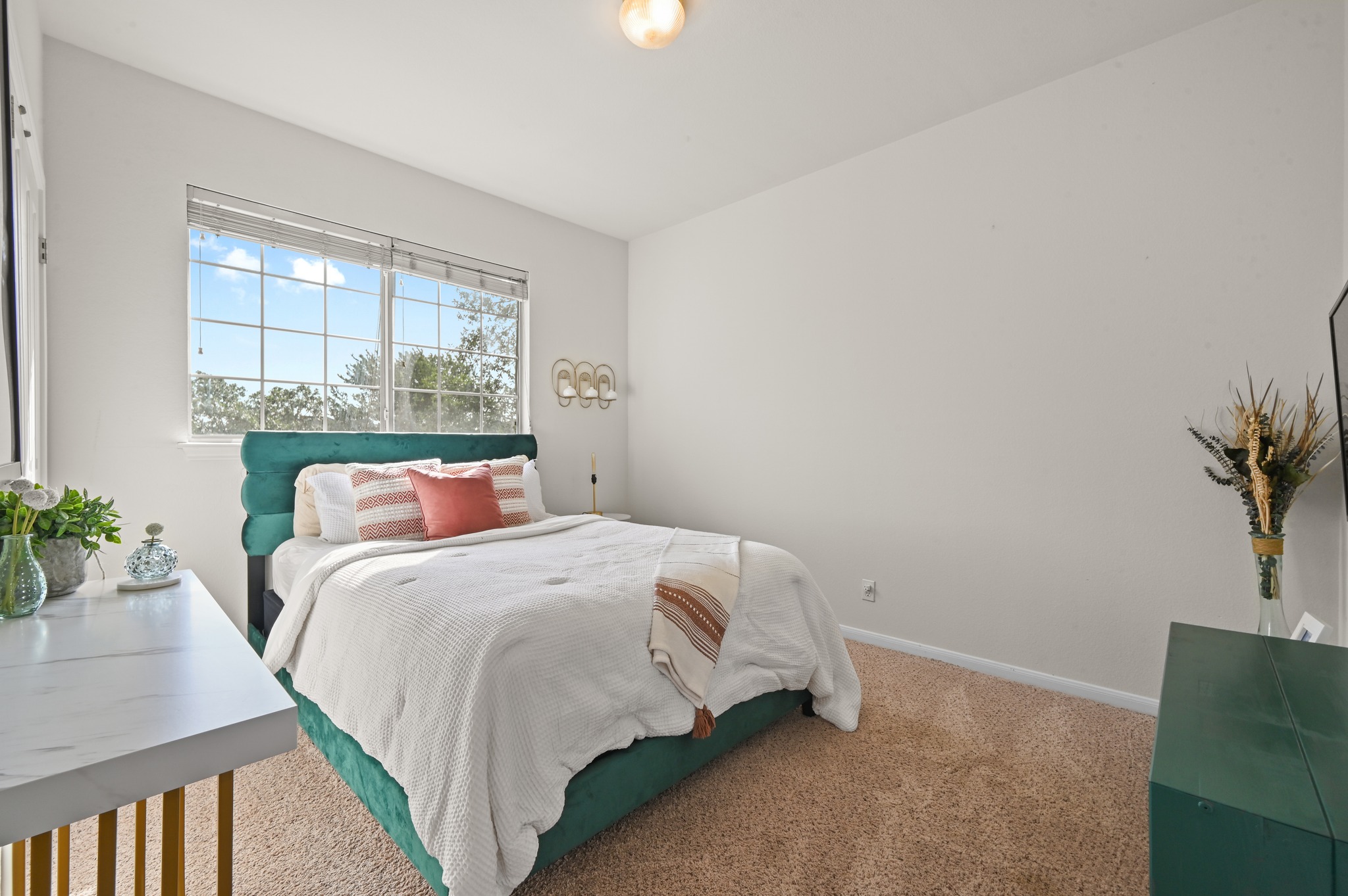 5888 Fergus Kyle, TX 78640 - Photo 23 of 40 A well-lit bedroom features plush carpet and ample natural light from a large window.