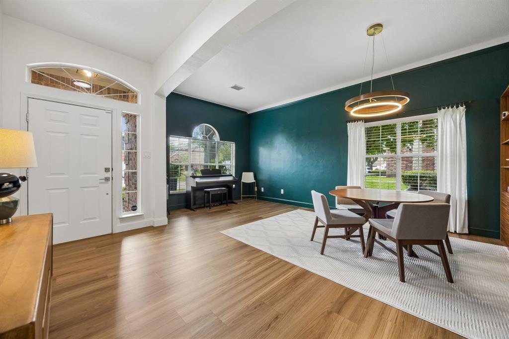 9217 Inverness Drive Rowlett, TX 75089 - Photo 2 of 40 A Striking First Impression — Bold color, tall ceilings, and updated lighting give this front living and dining space a memorable sense of personality the moment you step inside.