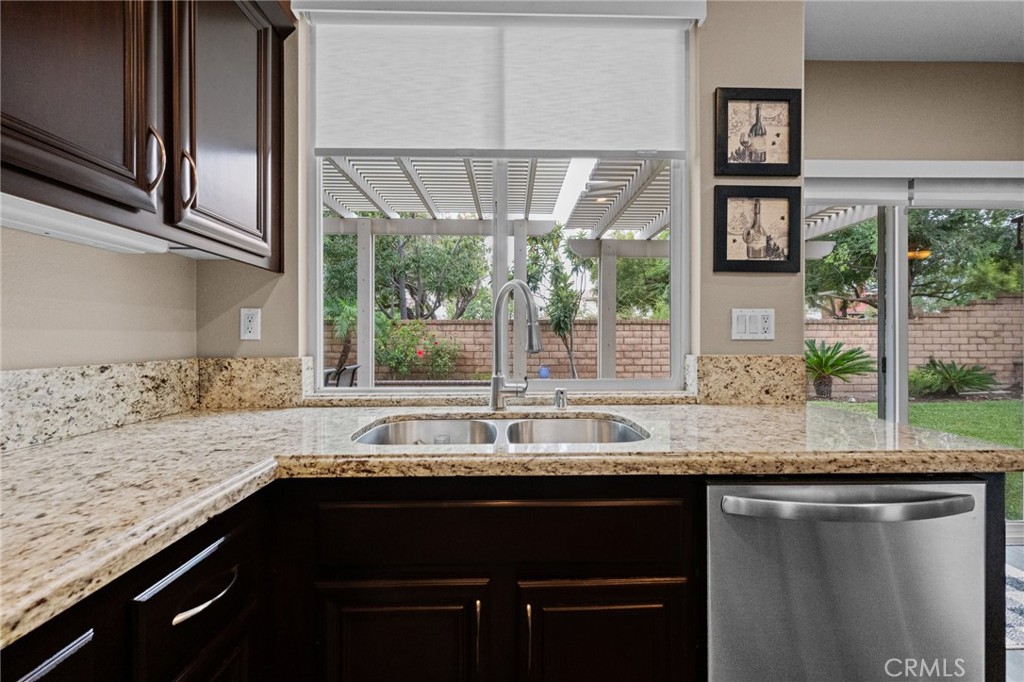 7220 Cumberland Place Rancho Cucamonga, CA 91739 - Photo 16 of 41 Kitchen sink overlooks the backyard, framed by a large window with natural light.