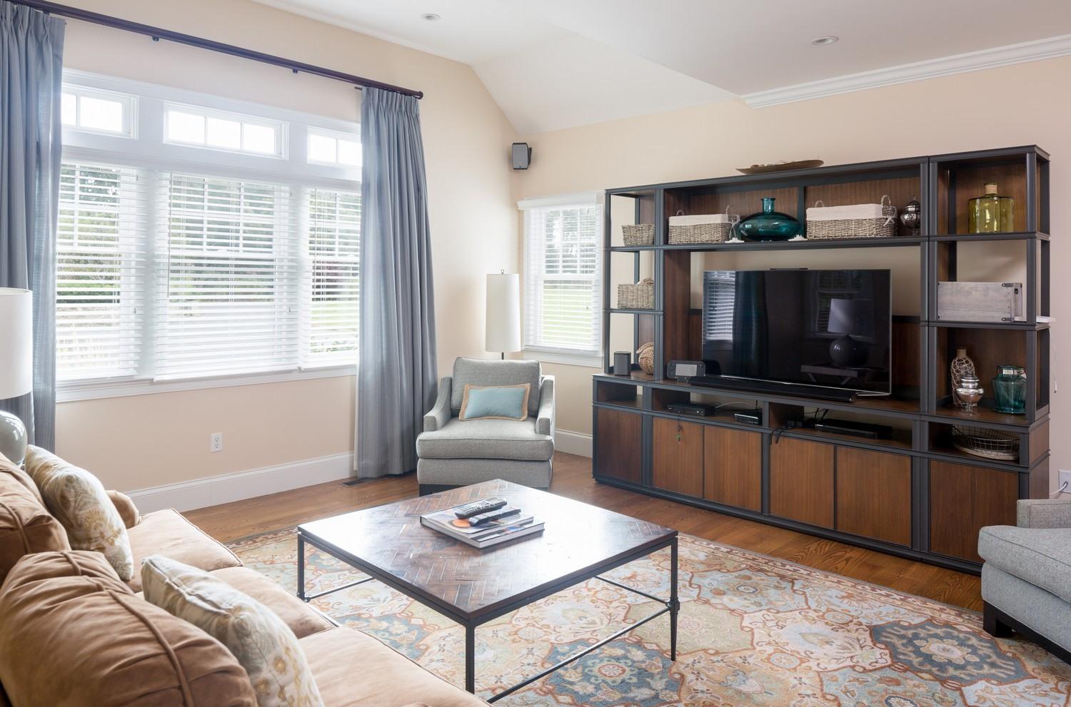 721 Samoset Road Eastham, MA 02642 - Photo 11 of 32 a living room with furniture a rug and a flat screen tv