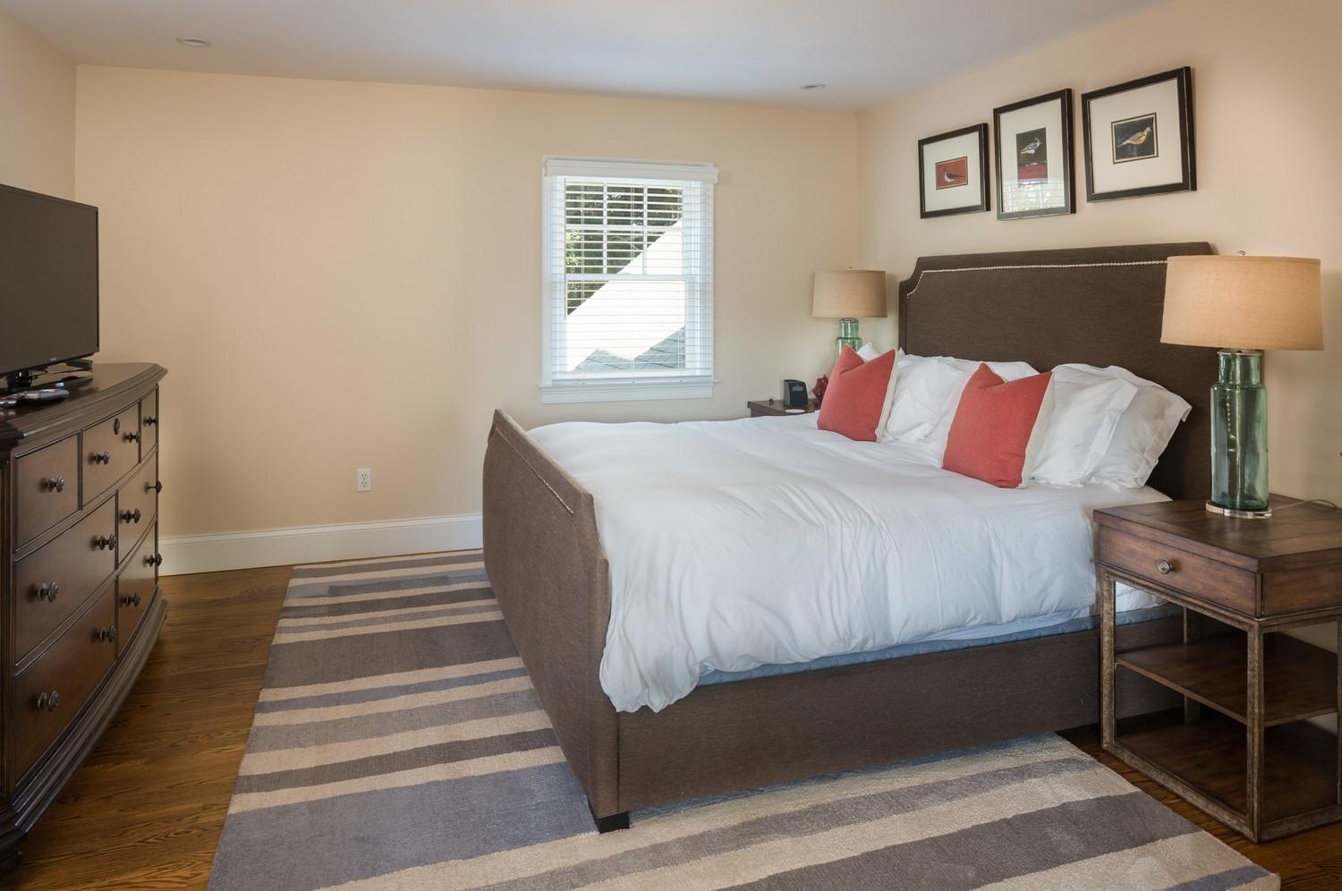 721 Samoset Road Eastham, MA 02642 - Photo 13 of 32 a bedroom with a bed and a flat tv screen on a dresser