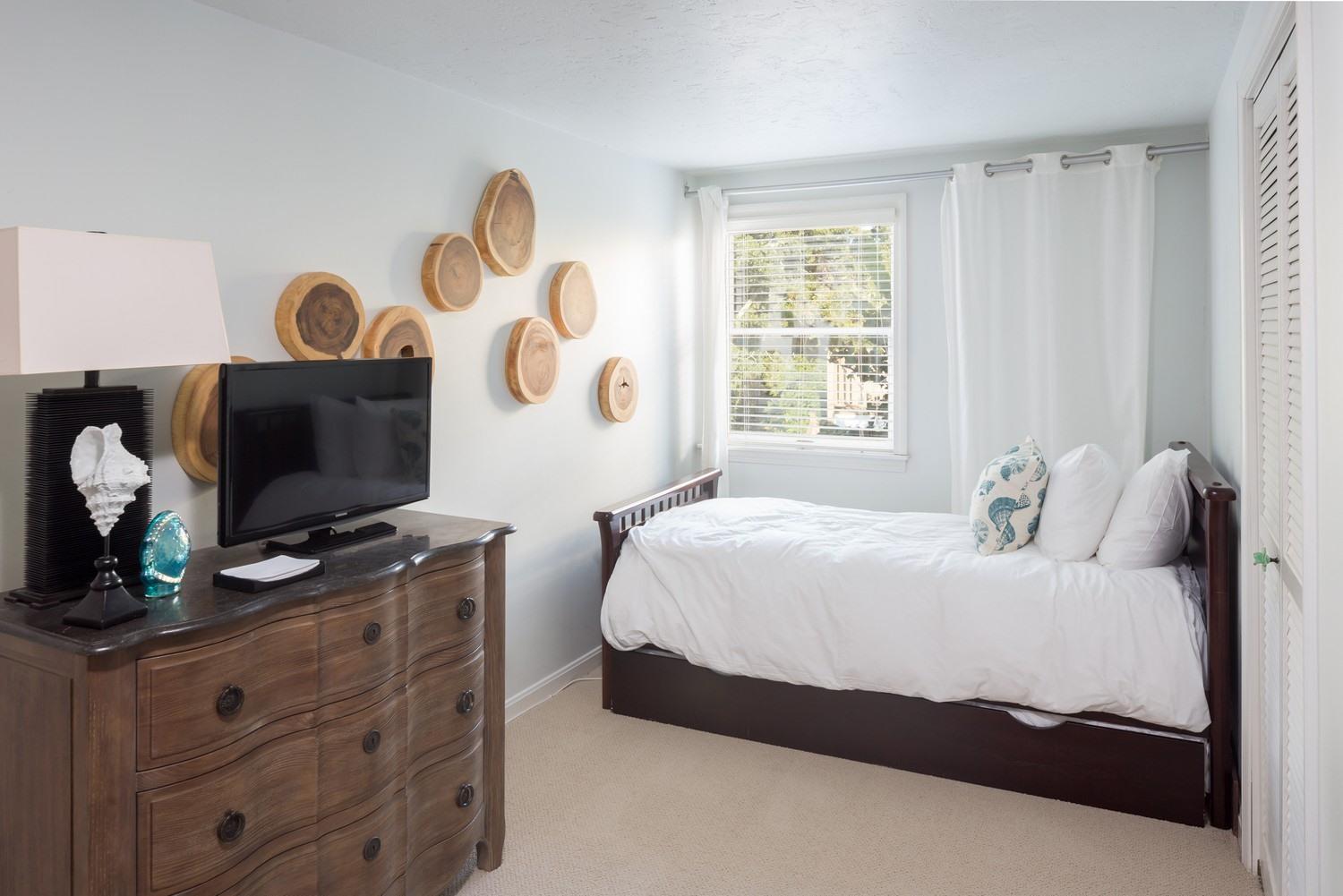 721 Samoset Road Eastham, MA 02642 - Photo 27 of 32 a bedroom with a bed and flat screen tv