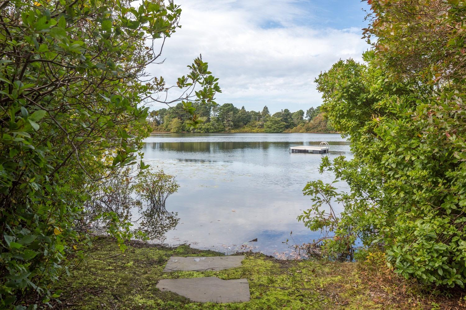 721 Samoset Road Eastham, MA 02642 - Photo 31 of 32 a view of a lake with a house in background