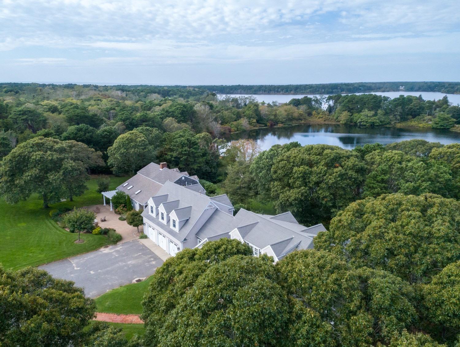 721 Samoset Road Eastham, MA 02642 - Photo 6 of 32 an aerial view of a house with a garden and lake view