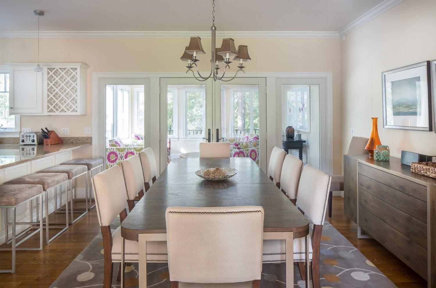 721 Samoset Road Eastham, MA 02642 - Photo 10 of 32 a view of a dining room with furniture a chandelier and wooden floor