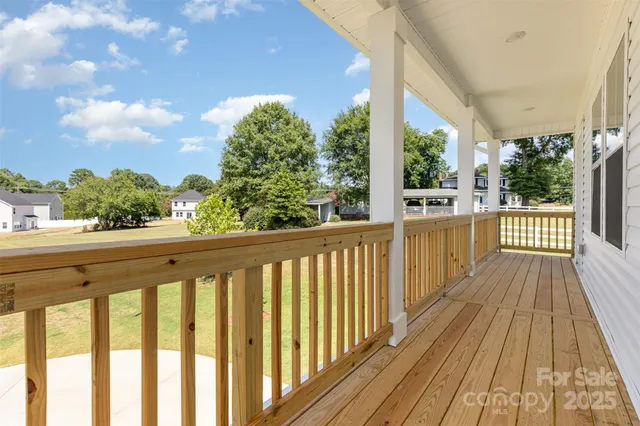 a view of a balcony with wooden floor