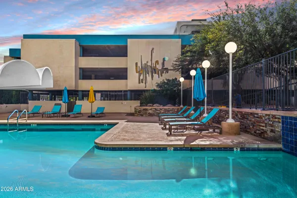 a view of a house with a swimming pool and sitting area
