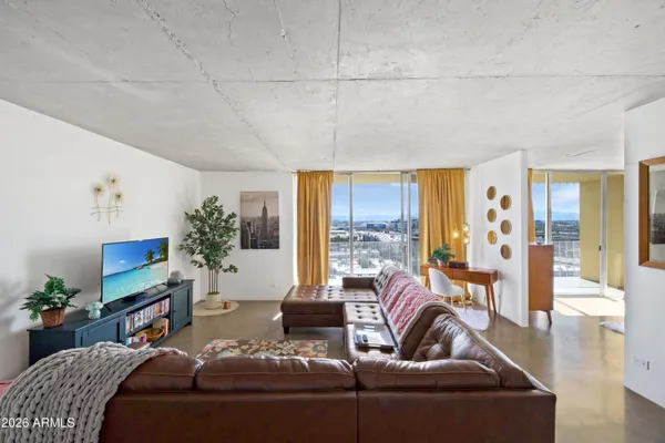 a living room with furniture and a potted plant