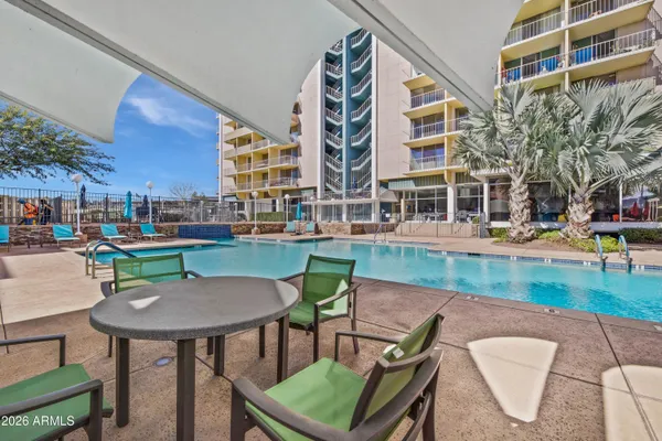 a backyard of a building with yard and outdoor seating