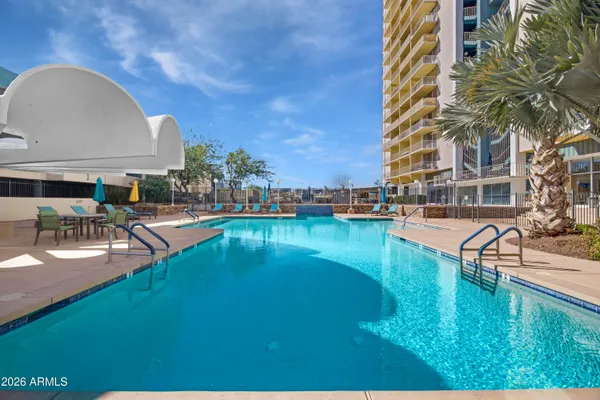 a swimming pool with outdoor seating and yard