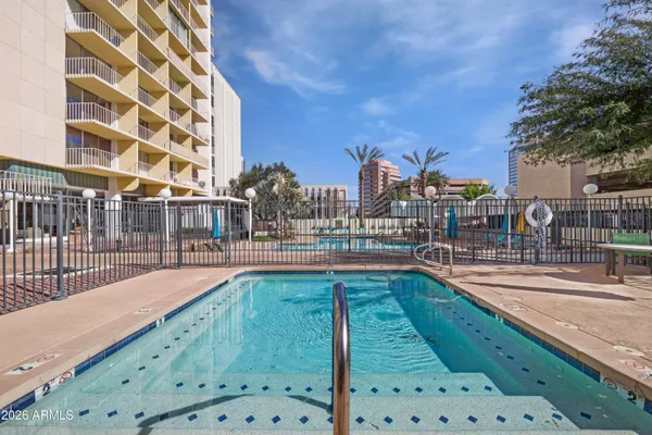a view of a swimming pool with a lawn chairs