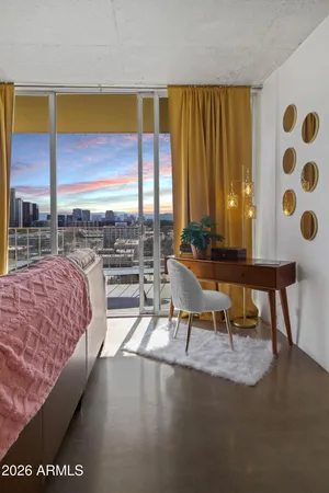 a living room with furniture and large windows