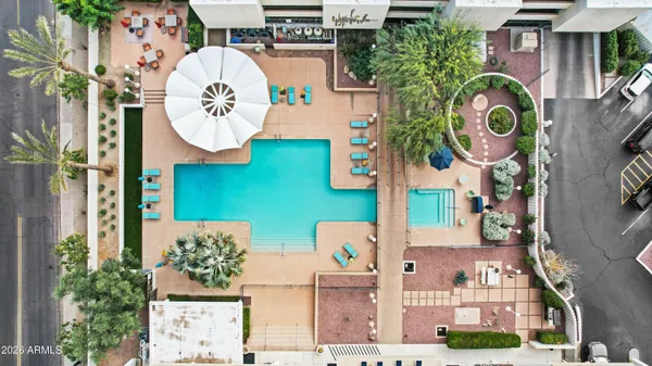aerial view of multi story residential apartment building with entryway and outdoor space