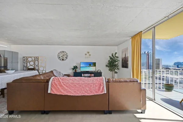 a living room with furniture and a floor to ceiling window