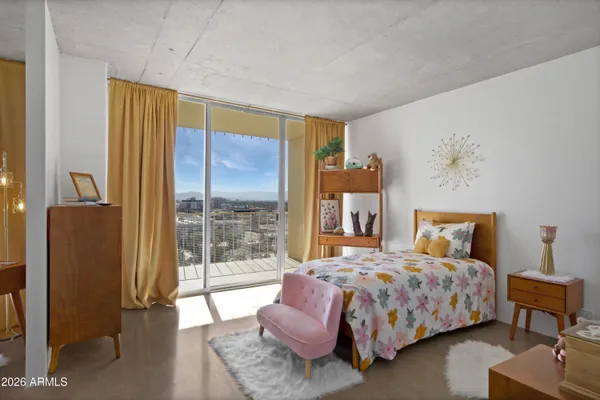 a bedroom with a bed and glass window