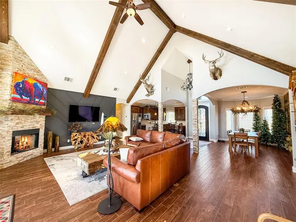 a living room with furniture a fireplace and a flat screen tv