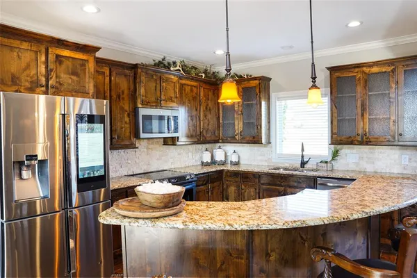 a kitchen with a sink a stove and a refrigerator