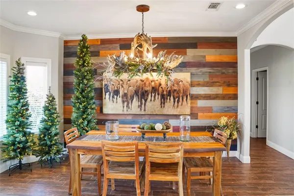 a dining room with furniture and wooden floor