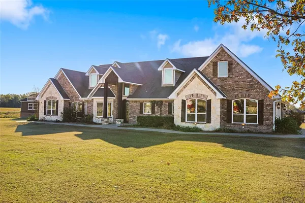 a front view of a house with swimming pool having outdoor seating