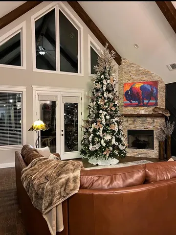 a kitchen with stainless steel appliances granite countertop a stove top oven a sink dishwasher a dining table and chairs with wooden floor