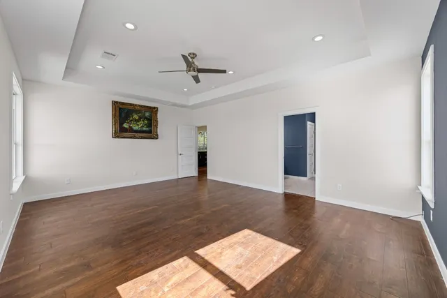 a spacious bathroom with a double vanity sink a mirror and a shower