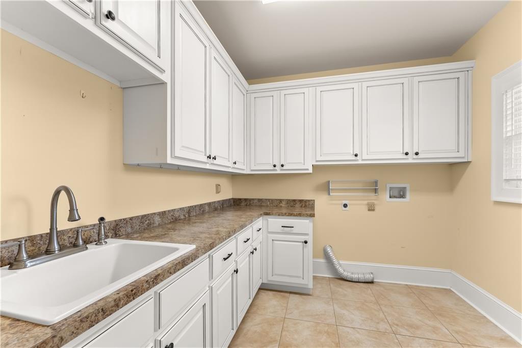 725 County Farm Road Jefferson, GA 30549 - Photo 35 of 66 a kitchen with a sink and cabinets
