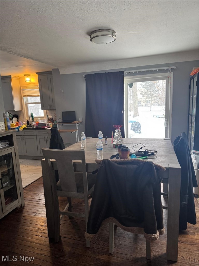 5164 Edenhurst Road Cleveland, OH 44124 - Photo 6 of 15 Dining room with dark wood-style flooring and a textured ceiling