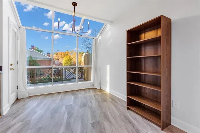 a view of a room with wooden floor and windows