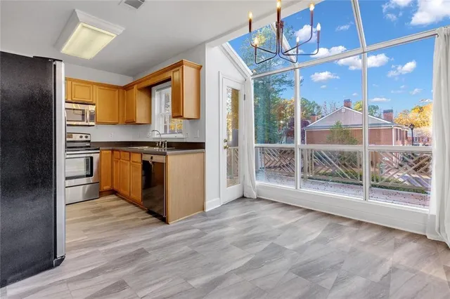 a open kitchen with stainless steel appliances granite countertop a stove and cabinets