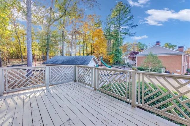 a view of a roof deck with wooden floor and fence