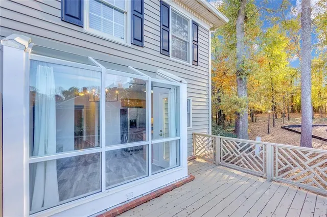 a view of a balcony with wooden floor and fence