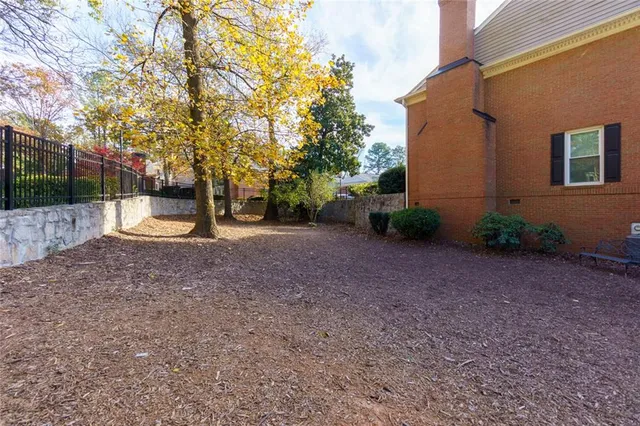 a view of a backyard with large trees
