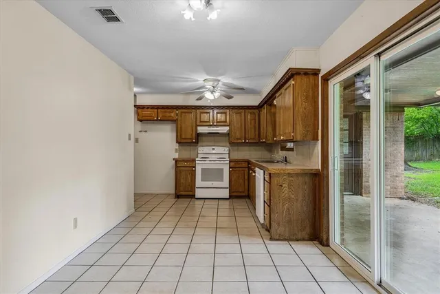 a kitchen with stainless steel appliances granite countertop a refrigerator and a stove