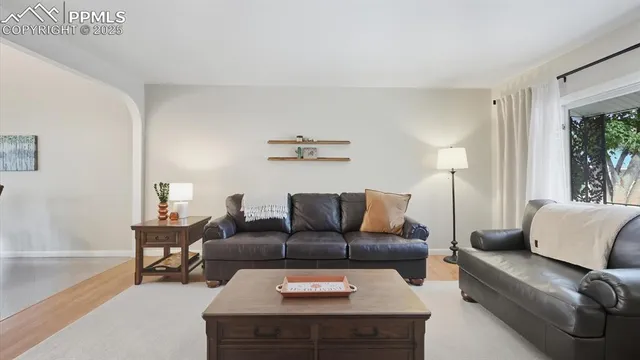 a living room with furniture and wooden floor