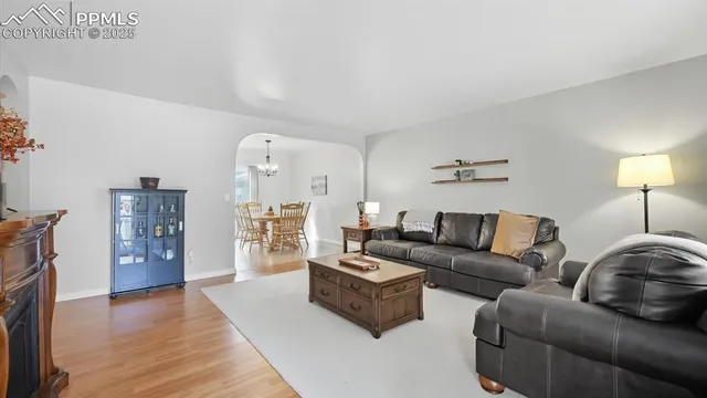 a view of a dining room with furniture wooden floor and chandelier