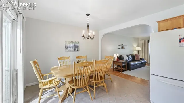 a view of a dining room with furniture and chandelier